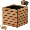 A wooden planter box with a black plastic insert, shown against a white background. A small tag with a logo is attached to the planter. Náhľad obrázku produktu