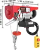 A red electric hoist with a hook and cable is shown against a white background, with dimensions indicated by measurement lines and text. Náhľad obrázku produktu