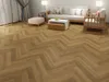 A living room scene with herringbone flooring, a sofa, coffee table, and ottoman. Produktbild-Vorschau