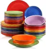 A collection of colorful ceramic plates and bowls stacked in various piles against a white background. Náhled obrázku produktu