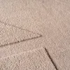 A close-up view of a textured beige rug with a subtle stitched pattern. Produktbild-Vorschau