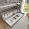 A bunk bed with a pull-out drawer, set in a bedroom with a window view. Produktbild-Vorschau
