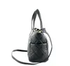 A black quilted handbag shown from the side against a white background. Náhľad obrázku produktu