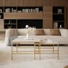 A modern living room with a sofa, coffee tables, and bookshelves. Voir les images du produit