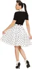 A woman wearing a 50s-style outfit, including a black top, a white polka dot skirt, and matching shoes and socks. Podgląd zdjęcia produktu