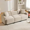 A beige sofa with two pillows in a living room setting. Anteprima dell’immagine prodotto