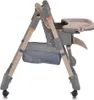 A side view of a beige and gray high chair with a tray and storage basket. Produktbild-Vorschau