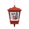 A red hanging Christmas lantern with a scene inside featuring Santa Claus, a lamppost, and a Christmas tree, set against a snowy backdrop. Náhľad obrázku produktu
