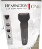 The image shows the packaging of a Remington ONE Total Body grooming kit. The packaging features a picture of the grooming device and lists its attachments and features. Produktbild-Vorschau