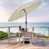 An outdoor patio set with a table, chairs, and umbrella overlooking the ocean. Anteprima dell’immagine prodotto