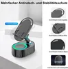 A black Bluetooth speaker with a phone stand attached, shown on a light gray surface. Produktbild-Vorschau