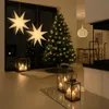 A festive Christmas scene with a decorated tree, star lanterns, and candles. Podgląd zdjęcia produktu
