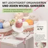 A pink and white yarn winder is shown on a table surrounded by various balls of yarn. Produktbild-Vorschau