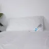 A white quilted pillow rests on a white duvet against a white wall. Produktbild-Vorschau