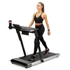 A woman is walking on a treadmill with a desk attached. Podgląd zdjęcia produktu