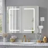 A bathroom vanity with a lighted medicine cabinet, sink, and faucet. Voir les images du produit