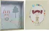 The image shows an open box with a scene inside and the lid of the box. The lid has a drawing of a girl and decorative elements. Produktbild-Vorschau