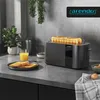 A modern kitchen counter with a toaster, toast, and orange juice. Podgląd zdjęcia produktu