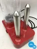 A close-up view of a red hot dog maker with two silver cooking prongs. Produktbild-Vorschau