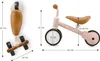 A size chart for a pink balance bike, showing dimensions and different views of the product. Voir les images du produit