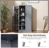 A grey pantry cabinet with its doors open, displaying shelves filled with food items and glassware. The image also includes a close-up of an anti-tip bracket and a diagram illustrating anti-tip safety. Produktbild-Vorschau