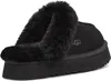 A black UGG slipper with a fluffy trim is shown from the side. Anteprima dell’immagine prodotto