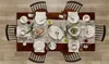 A dining table set for a meal with plates, cutlery, and bread. Náhľad obrázku produktu