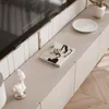 A modern living room with a TV stand and decorative items. Produktbild-Vorschau