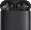 A close-up, front-facing view of black wireless earbuds in their charging case. Podgląd zdjęcia produktu