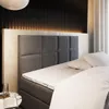 A bedroom scene with a bed and headboard. Produktbild-Vorschau