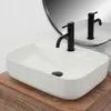 A white rectangular vessel sink with a black faucet is shown on a wooden countertop, with a mirror reflecting the scene. Náhľad obrázku produktu