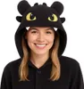 A woman wearing a black dragon-themed onesie costume. Anteprima dell’immagine prodotto