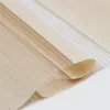 A close-up, angled view of a rolled-up fabric blind, showing its layered texture and striped pattern. Voir les images du produit