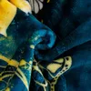 A close-up of a folded blanket with a butterfly pattern. Produktbild-Vorschau