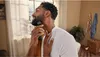 A man is trimming his beard in a bathroom. Anteprima dell’immagine prodotto