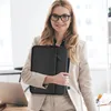 A woman in a business suit holds a black laptop bag. Anteprima dell’immagine prodotto