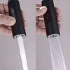 Two close-up shots of a black faucet head, showing two different water spray patterns. Produktbild-Vorschau