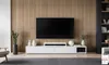 A modern living room with a large television mounted on a wood-paneled wall, a white media console, and decorative items. Anteprima dell’immagine prodotto