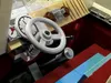 Close-up view of a Lego model car interior, focusing on the steering wheel and dashboard. Podgląd zdjęcia produktu