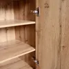 A close-up view of the interior of a wooden cabinet, showing shelves and hinges. Produktbild-Vorschau