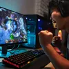 A person is intensely playing a video game on a computer. Produktbild-Vorschau