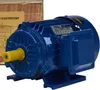 A blue electric motor is shown in a studio setting with a wooden box in the background. Voir les images du produit