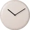 A minimalist wall clock with a textured beige face and black hands. Voir les images du produit