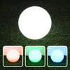 A large white sphere is shown on a green, grassy background, with three smaller spheres below it, each illuminated with a different color (pink, green, and blue). Podgląd zdjęcia produktu