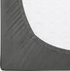 A close-up view of a fitted sheet on a mattress. Náhled obrázku produktu