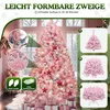 A decorated pink Christmas tree in a room with gifts underneath. Produktbild-Vorschau