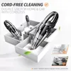 A 3D rendering of a cordless handheld vacuum cleaner being used to clean up debris in a stylized, minimalist house layout. Produktbild-Vorschau