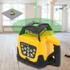 A yellow and black rotary laser level is shown in an empty room with wooden floors and large windows. Podgląd zdjęcia produktu