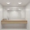 A modern bathroom vanity with a large mirror and a ceiling light. Náhľad obrázku produktu