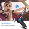 A woman driving a car while wearing a Bluetooth headset. Produktbild-Vorschau
